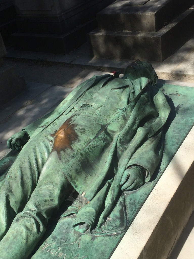 Copper statue of a man with polish marks in the crotch area