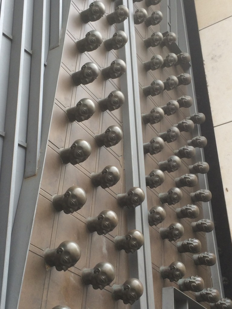 Door with rows of creepy head protrusions in Prague