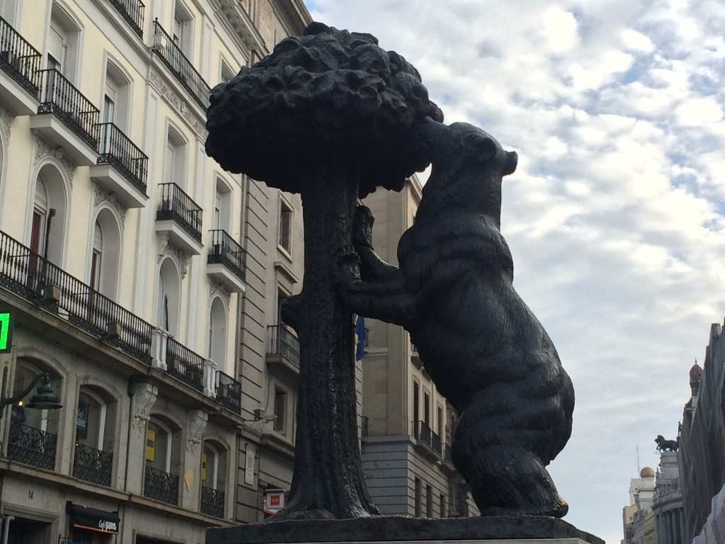 This bear trying to eat strawberries from a tree is a symbol of the city. J'approve, even though strawberries don't grow on trees.